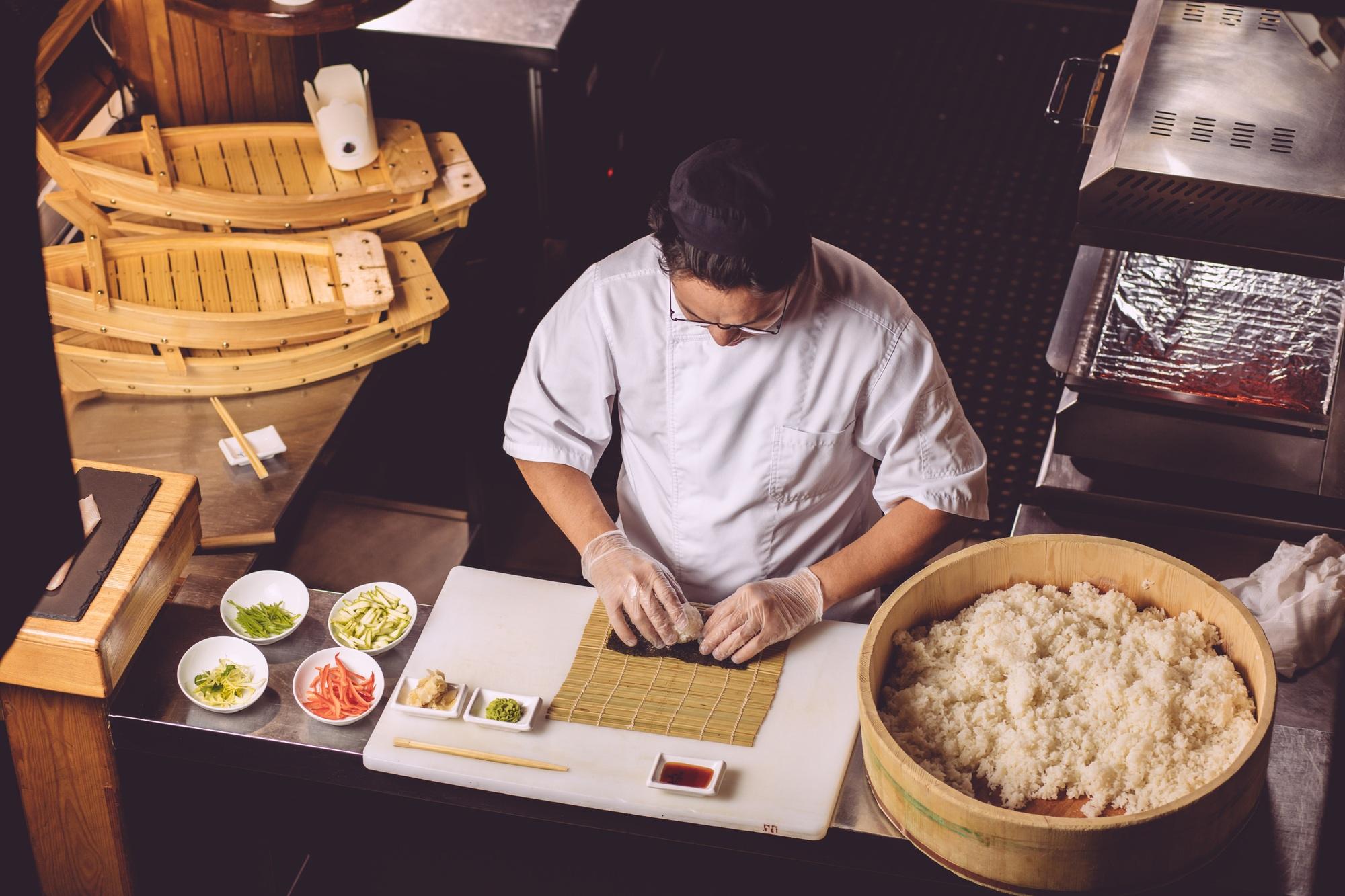 experienced chef preparing sushi in the kitchen
